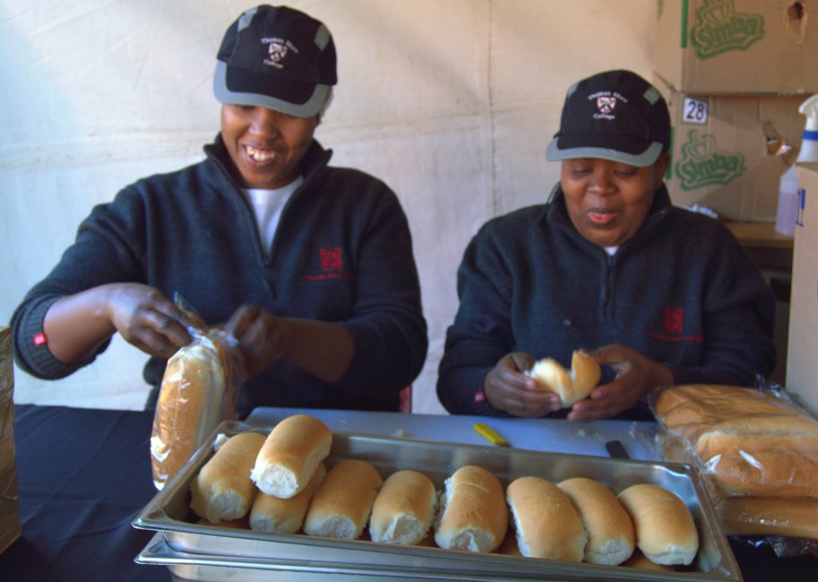 Nokuthula and Vicky in the Dog House cutting rolls